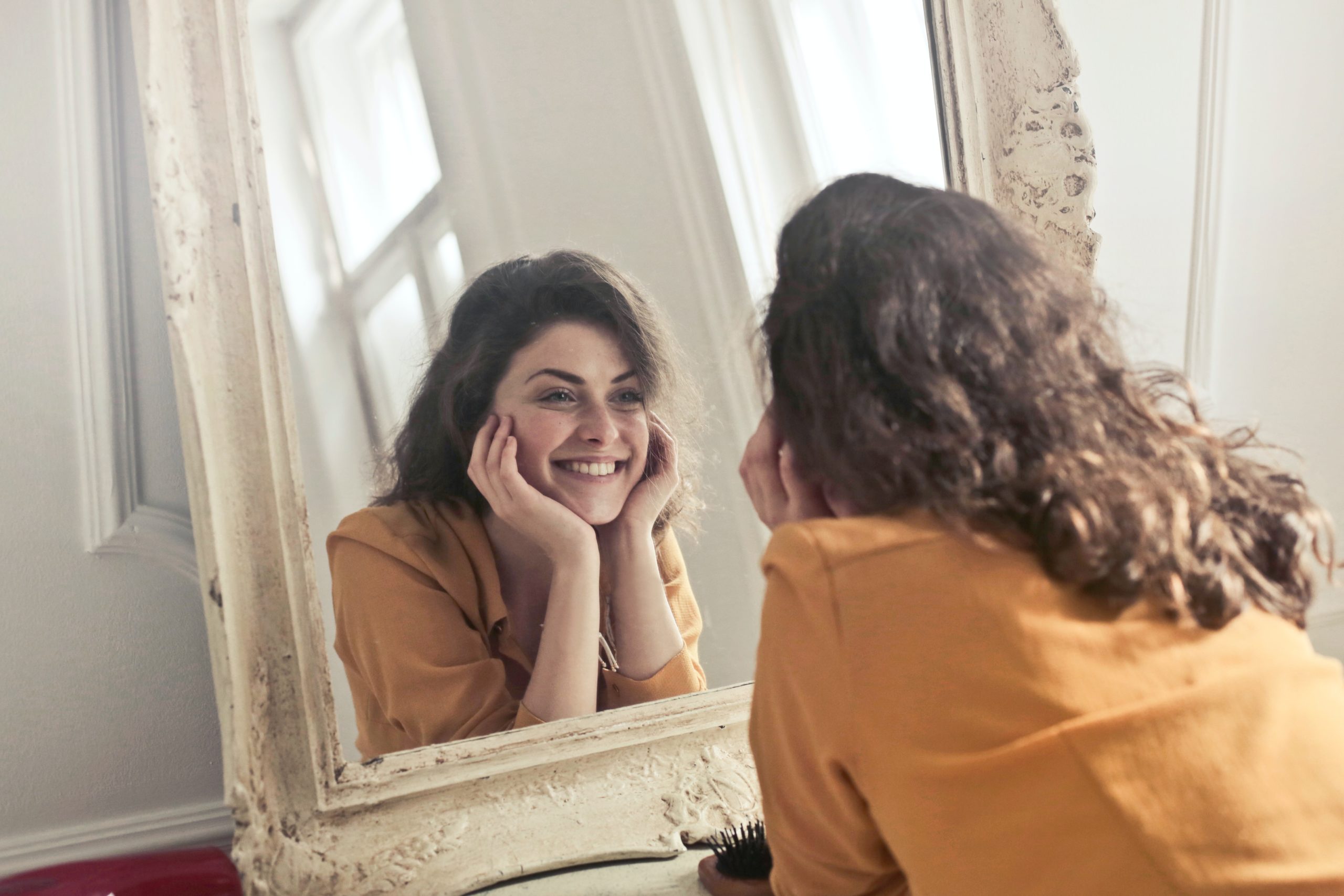 girl in mirror finding herself again after trauma