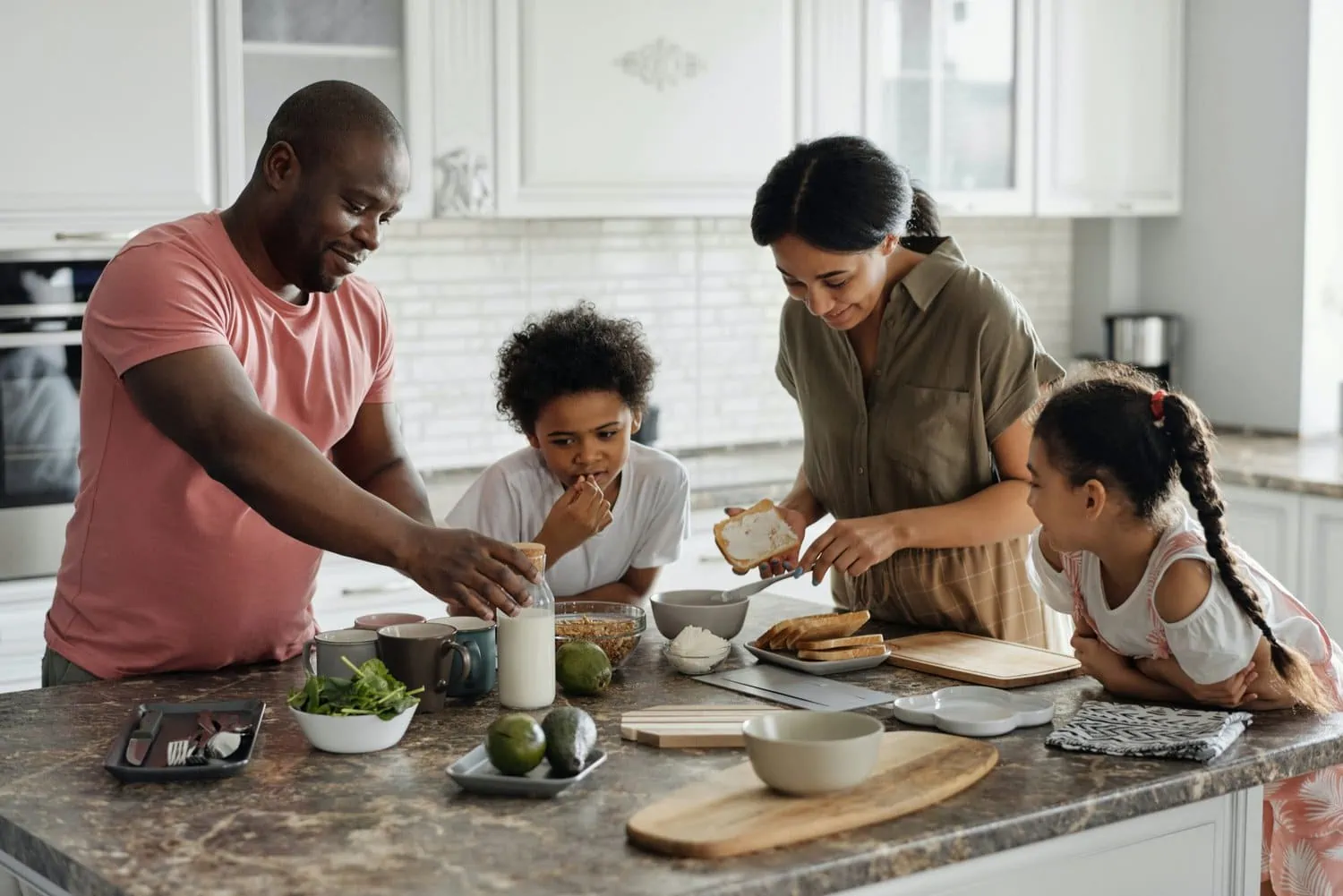 Happy family making dinner together thinking about what does family mean