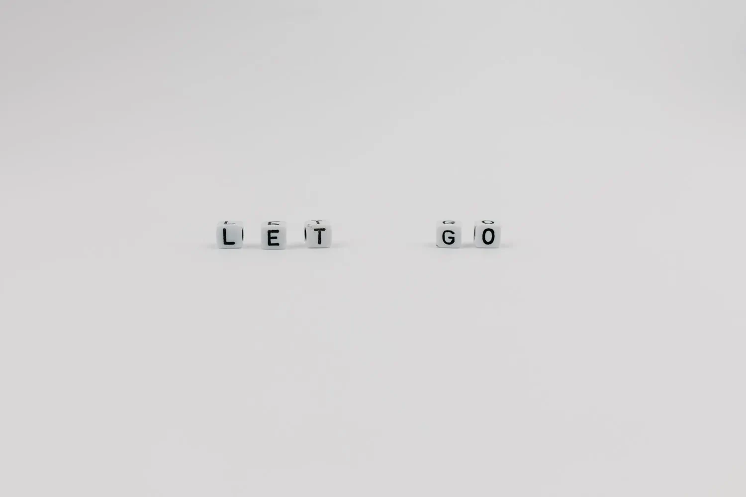 Letters writing out let go which is a message for those researching how to break emotional attachment to things