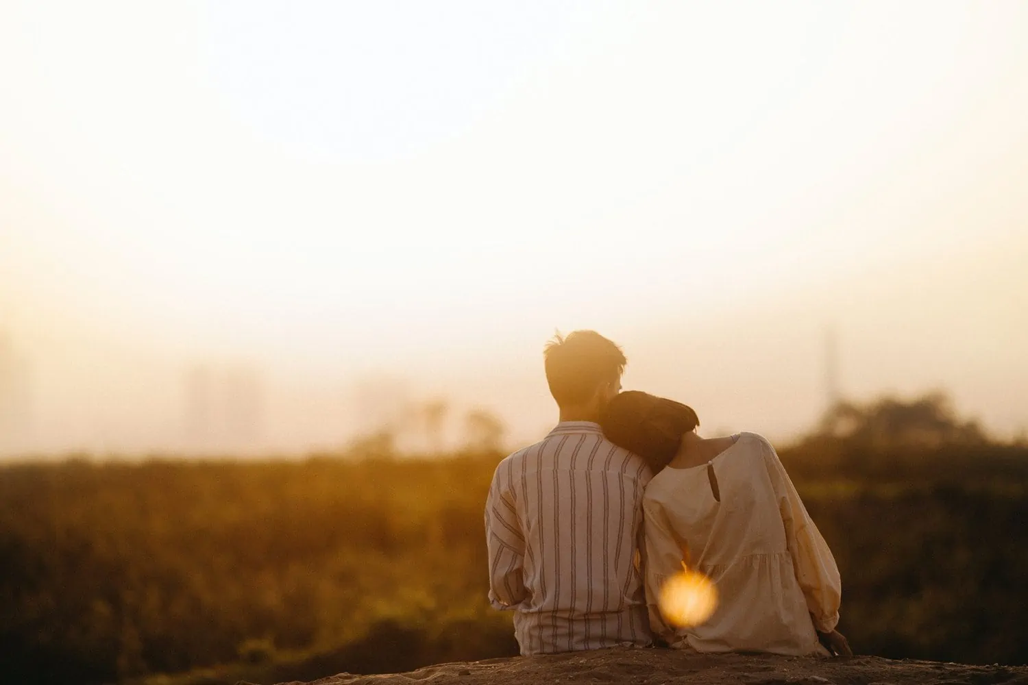 two people in love looking at the sunset